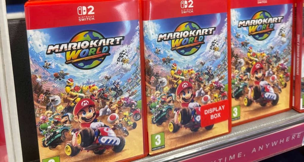 Three copies of Mario Kart World for the Nintendo Switch 2 on a store shelf
